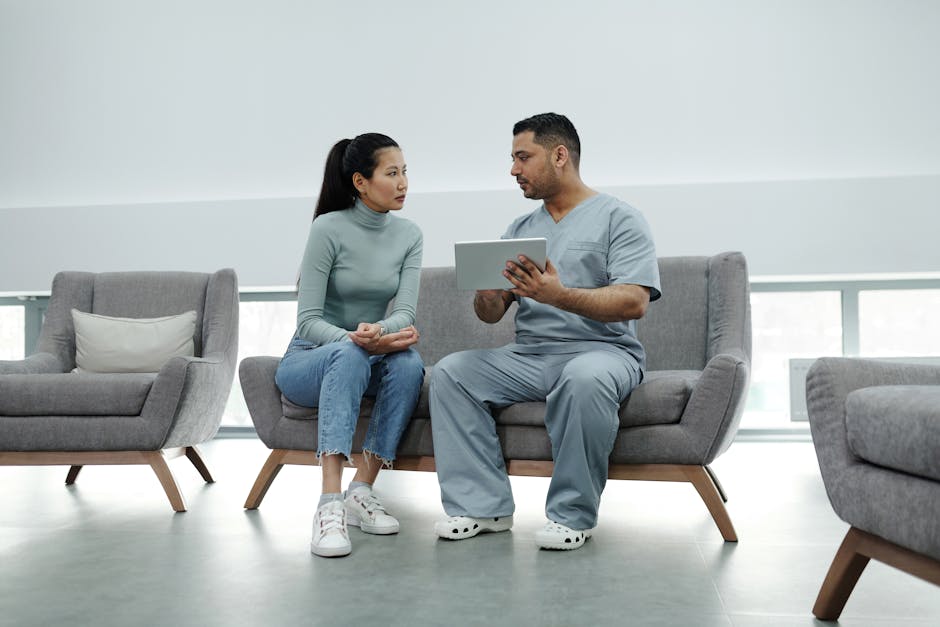 Healthcare provider consulting a patient with a tablet, emphasizing technology in healthcare.